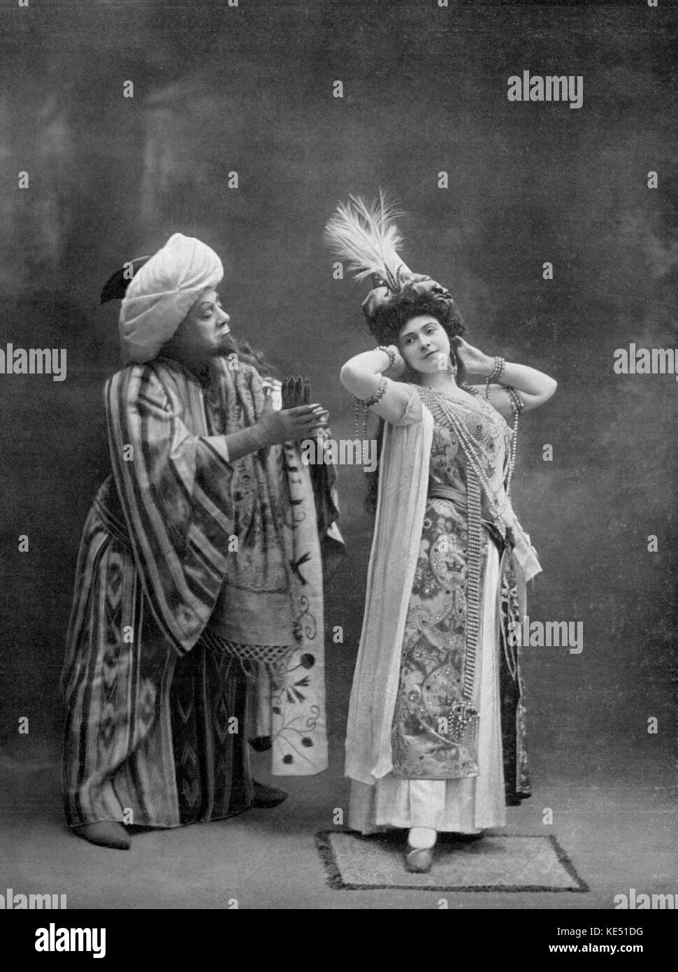 Lucien Fugére as the Devil and Jean-Louise Tiphaine as Fiamina in Act II of Jules Massenet 's opera Grisélidis Premiered at the Opéra -Comique, Paris, France. 20 November 1901.  JM: French composer, 12 May 1842 - 13 August 1912 LF: Franch Baritone, 22 July 1848 - 15 January 1935 JLT: French soprano, 20 Aug 1873 - Sep 1958 Stock Photo