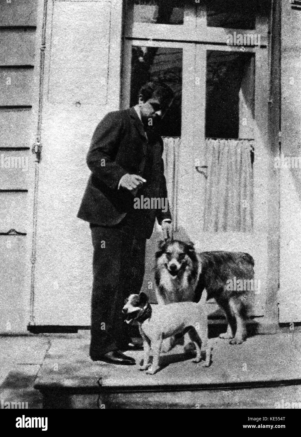 Claude Debussy with his fox terrier 'Boy' and collie  'Xanto' outside his house, 1907. CD: French composer, 22 August 1862 - 25 March 1918. Stock Photo