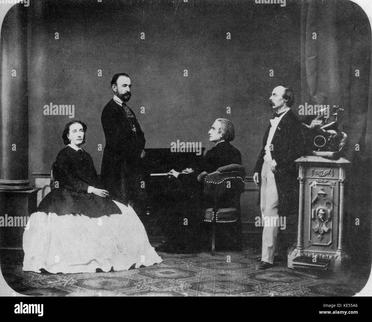 Franz Liszt at the piano, his daughter Cosima, unknown man standing next to her, Hans Von Bulow to the right of Liszt.  Bayreuth.. Stock Photo