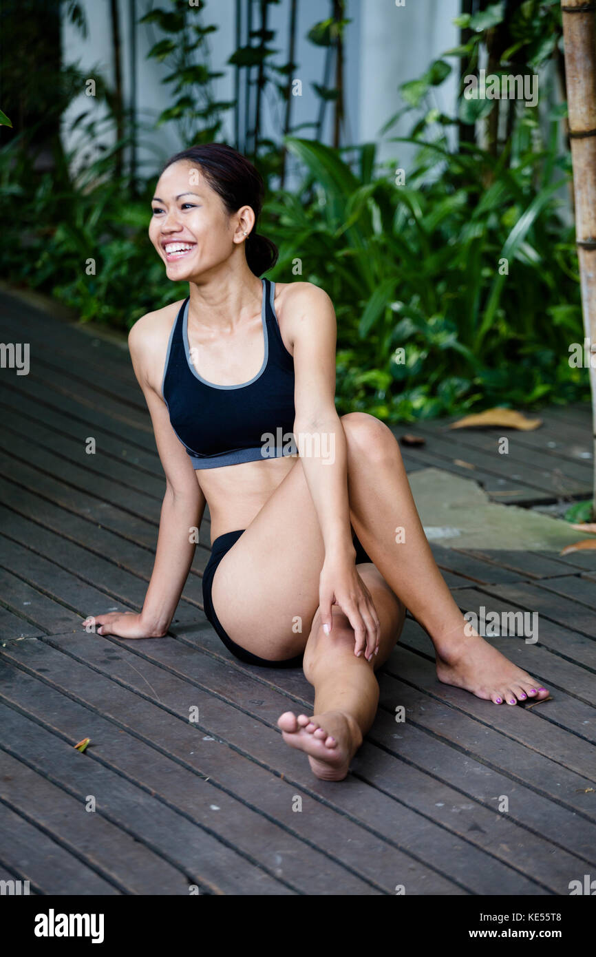 Young Khmer woman exercising outdoors Stock Photo