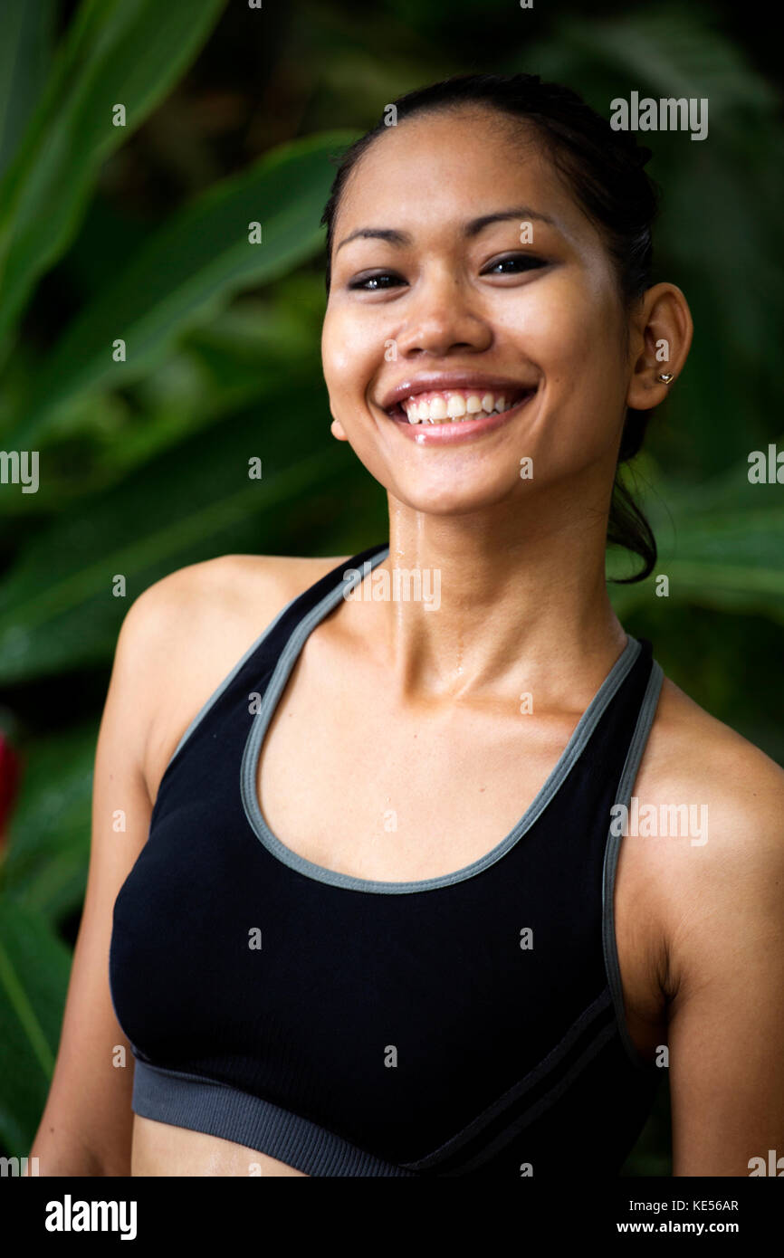 Smiling Asian woman in fitness clothes Stock Photo