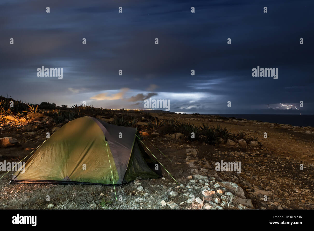 A camping tent set up during a thunderstorm Stock Photo - Alamy