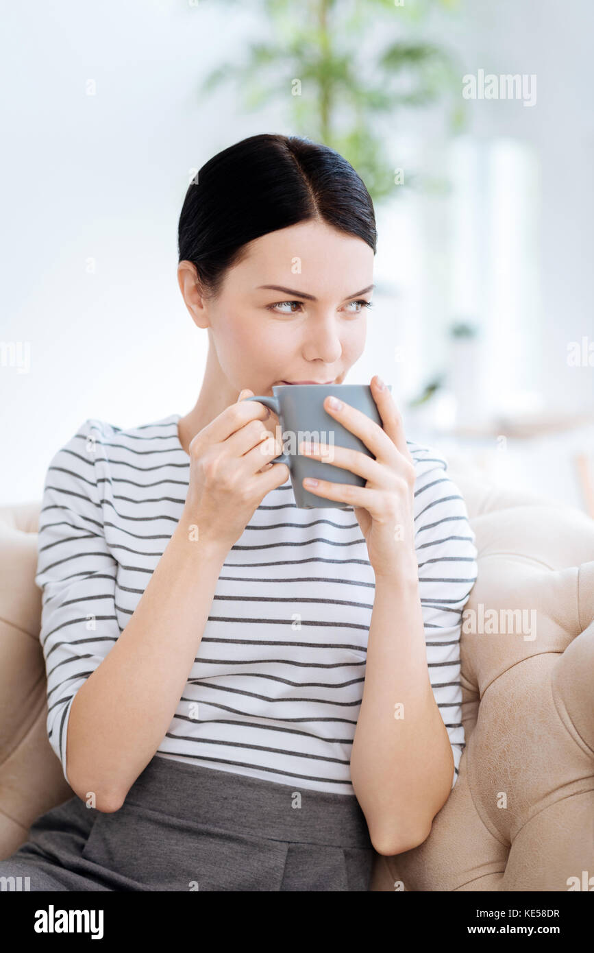 Positive young woman holding a cup Stock Photo