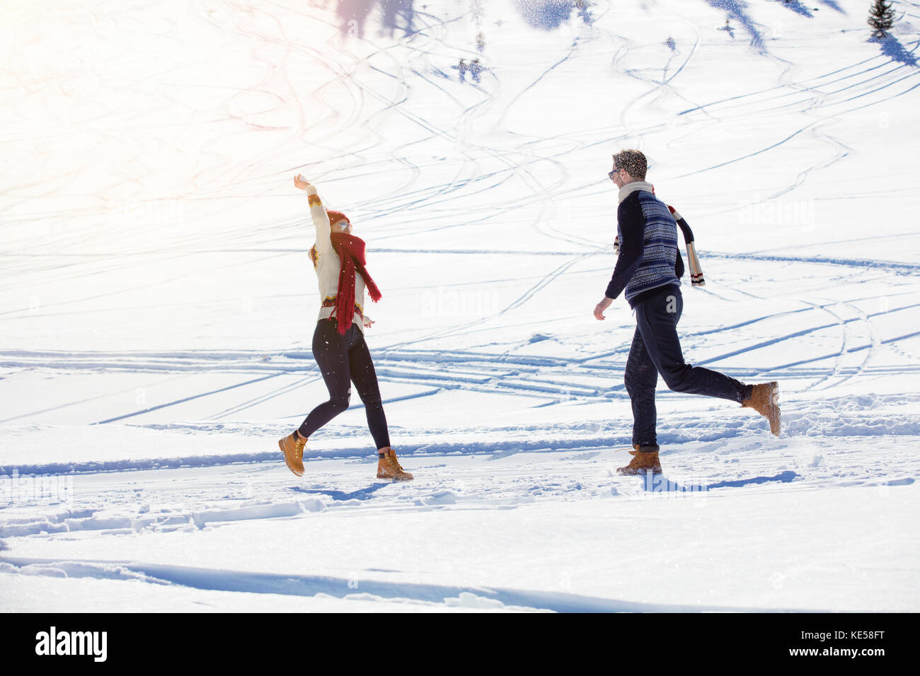 Carefree happy young couple having fun together in snow Stock Photo - Alamy