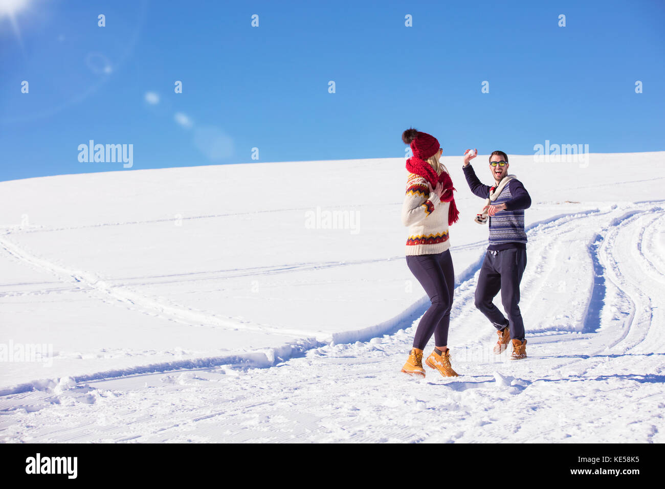 Carefree happy young couple having fun together in snow Stock Photo - Alamy
