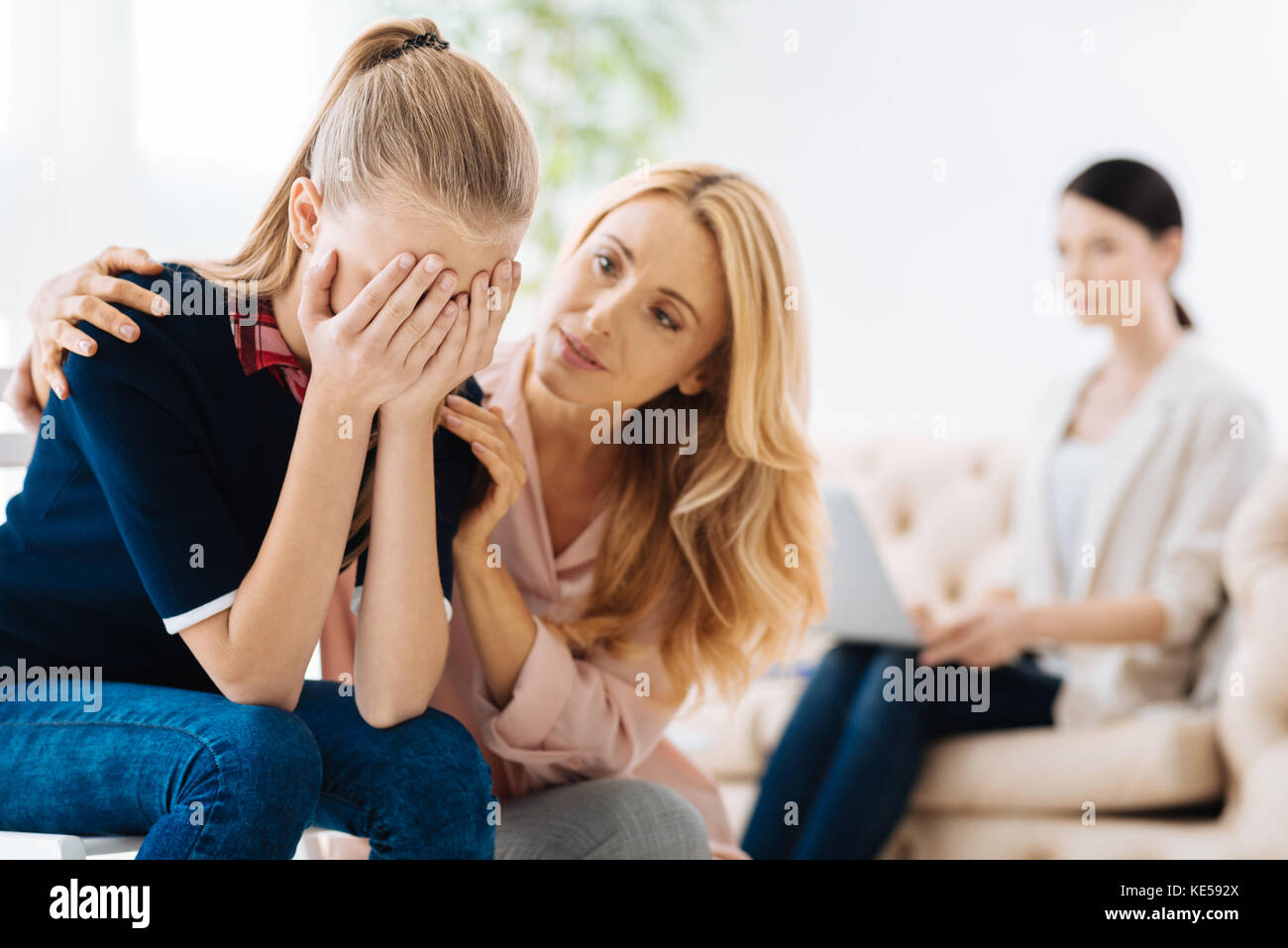 Beautiful adult woman consoling her daughter Stock Photo