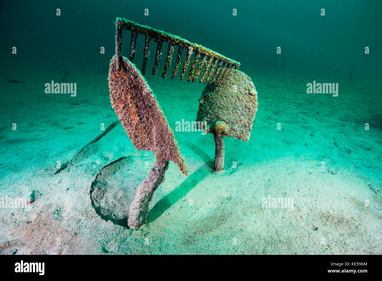 Work tools buried in the sand of Lake McDonald, Montana. Stock Photo