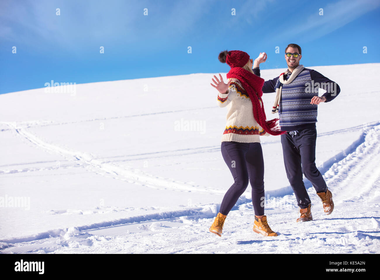 Carefree happy young couple having fun together in snow Stock Photo - Alamy