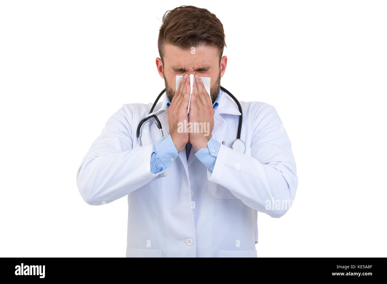 Doctor sneezing isolated against white background Stock Photo