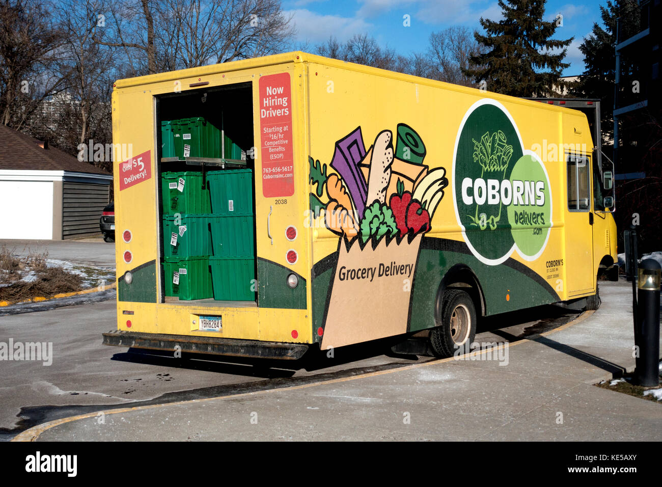 Coborns Delivers.com yellow grocery delivery truck loaded with green baskets filled with fresh groceries being delivered. St Paul Minnesota MN USA Stock Photo