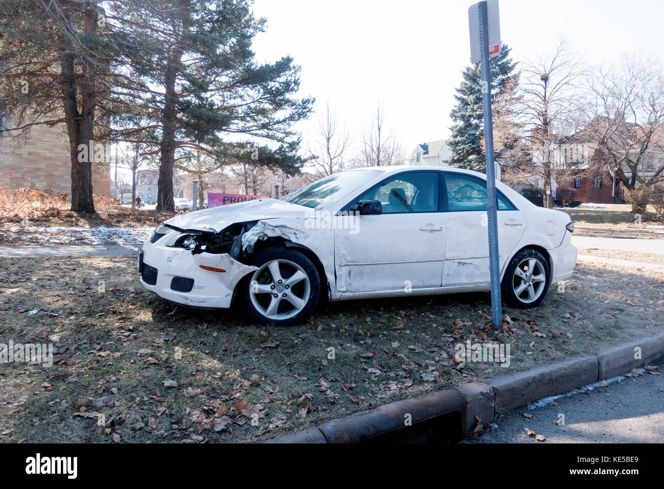 Automobile with crunched up fender ends up on grass after being in an accident. St Paul Minnesota MN USA Stock Photo