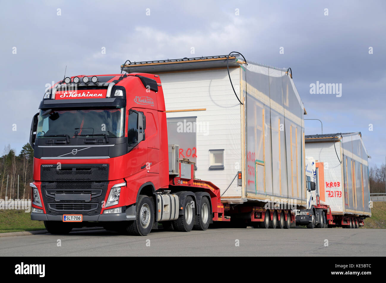 FORSSA, FINLAND - APRIL 23, 2016: Volvo FH semi and another truck are ready to transport prefabricated house modules as oversize loads in South of Fin Stock Photo