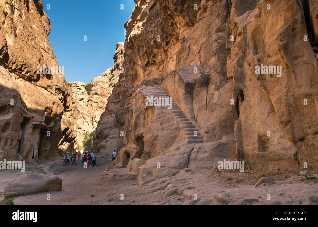 Nabataean ruins carved in sandstone cliff,  Little Petra, Siq al-Barid, with steep carved steps, archaeological site, Wadi Musa, Jordan, Middle East Stock Photo