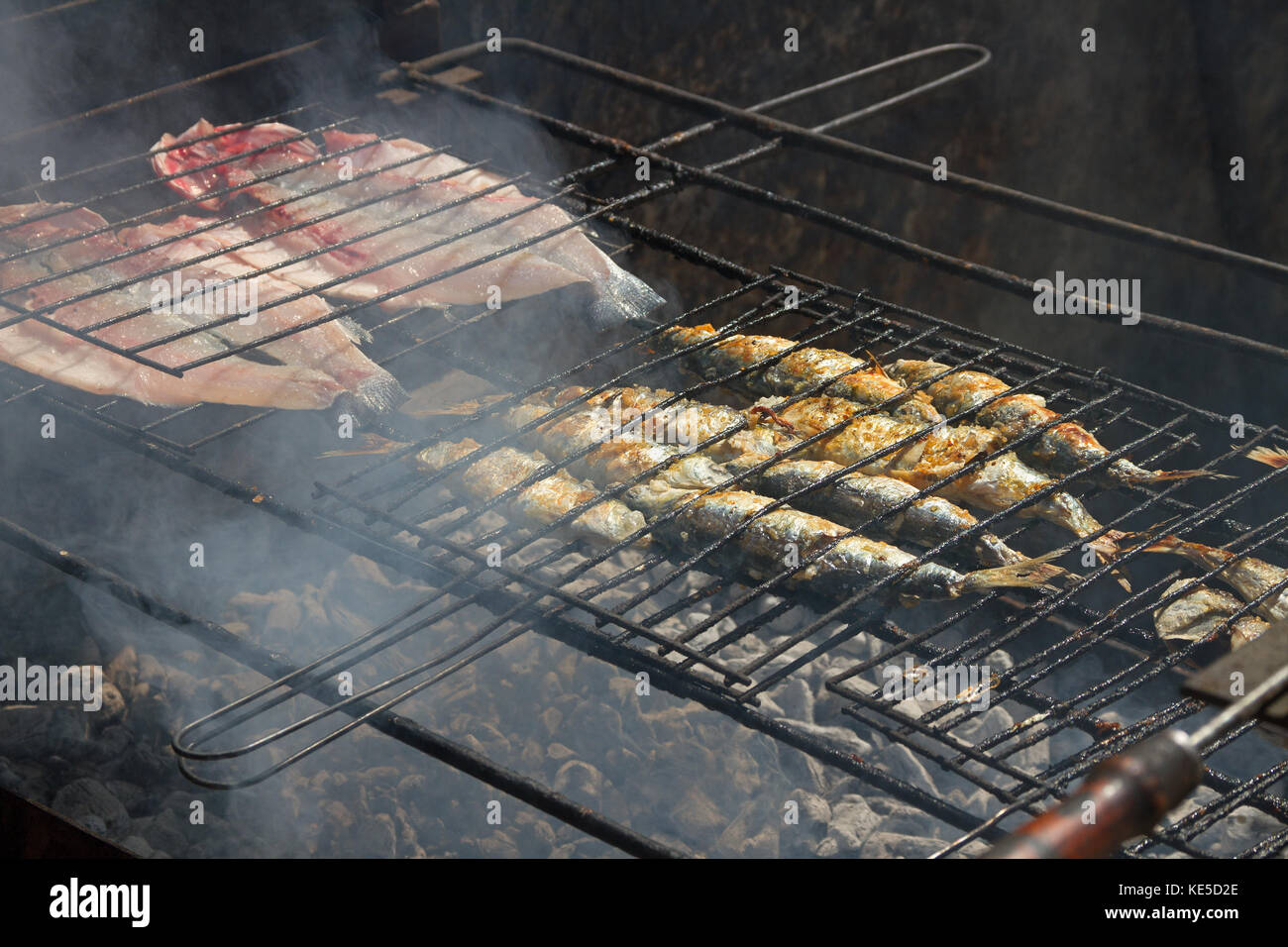 Fried fish on a hot coal on the banks of the river Dora in Afurada, Portugal. Stock Photo