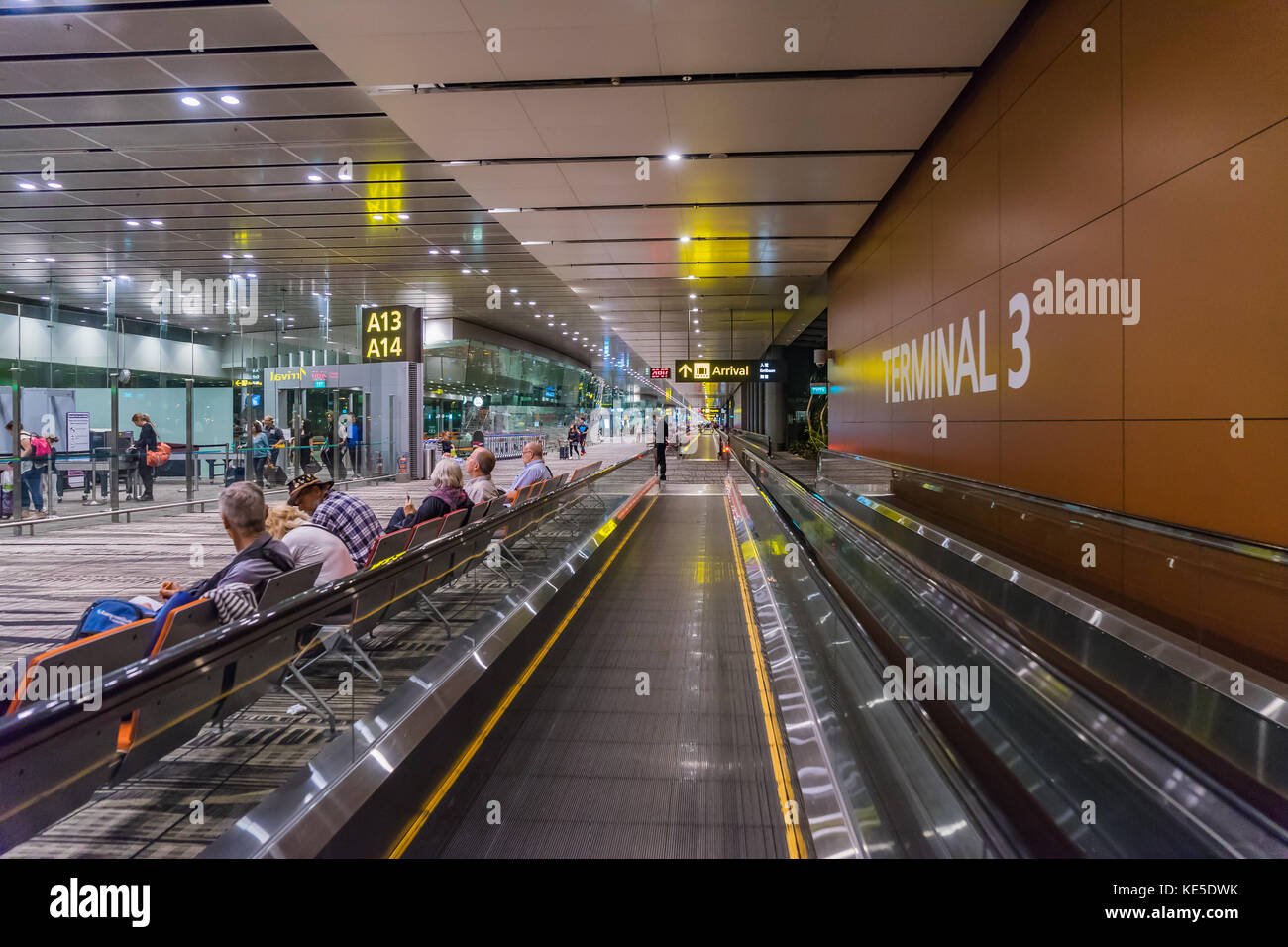 Singapore - July 16, 2017: Visitors walk around Departure Hall in Changi Airport. It has 4 passenger terminals, and is one of the largest transportati Stock Photo