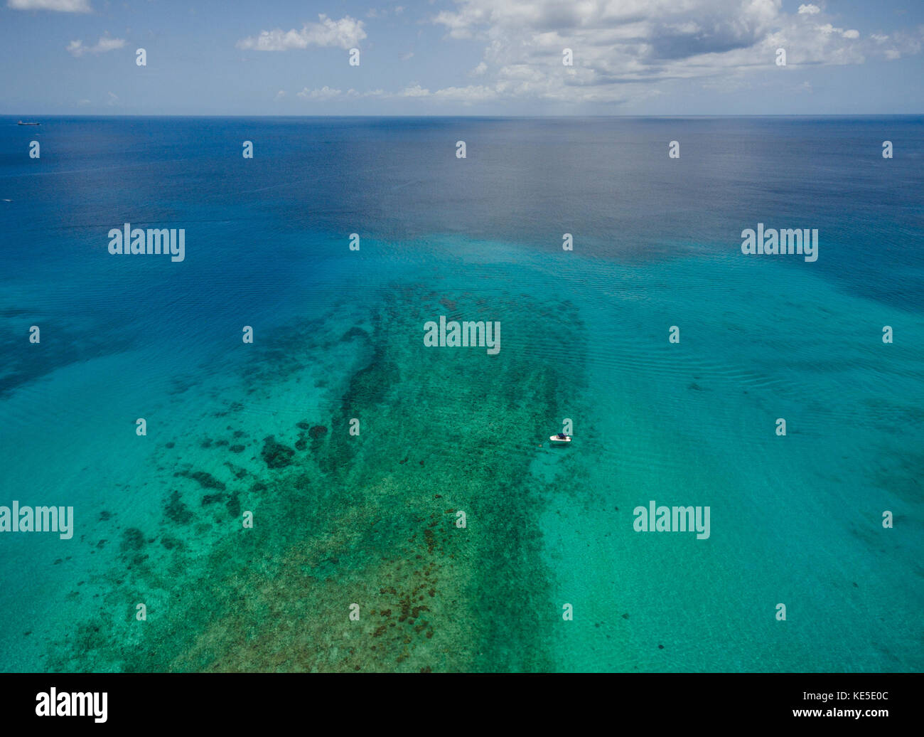 A dive boat anchored over a reef at Mullins Beach on the Caribbean