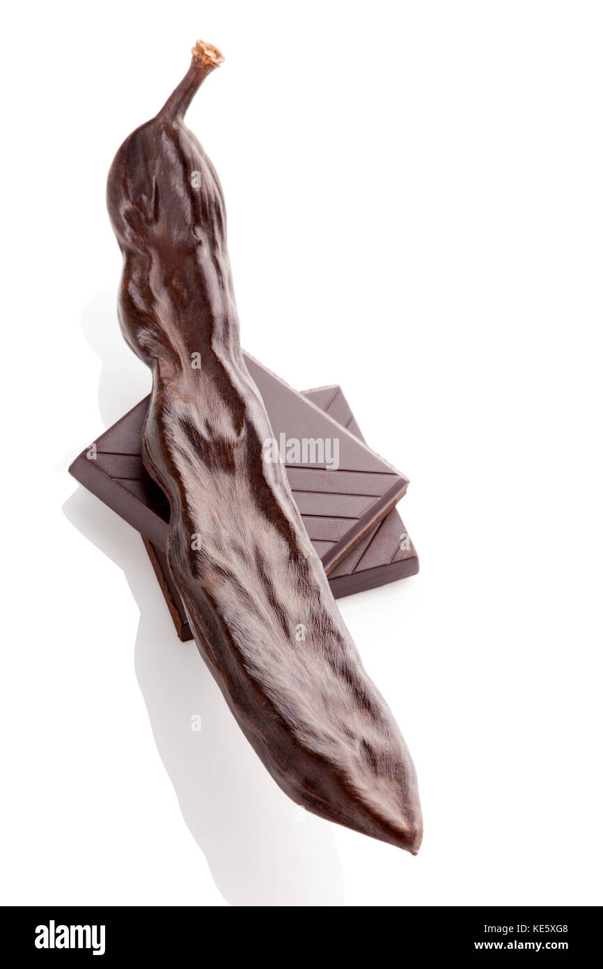 Carob pod and carob chocolate isolated on white background Stock Photo