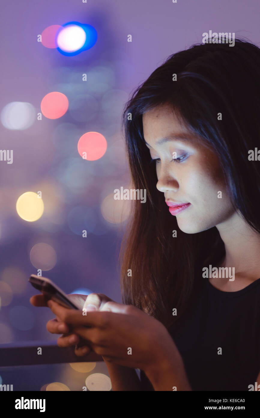 Young Asian Woman on her Cell Phone Stock Photo