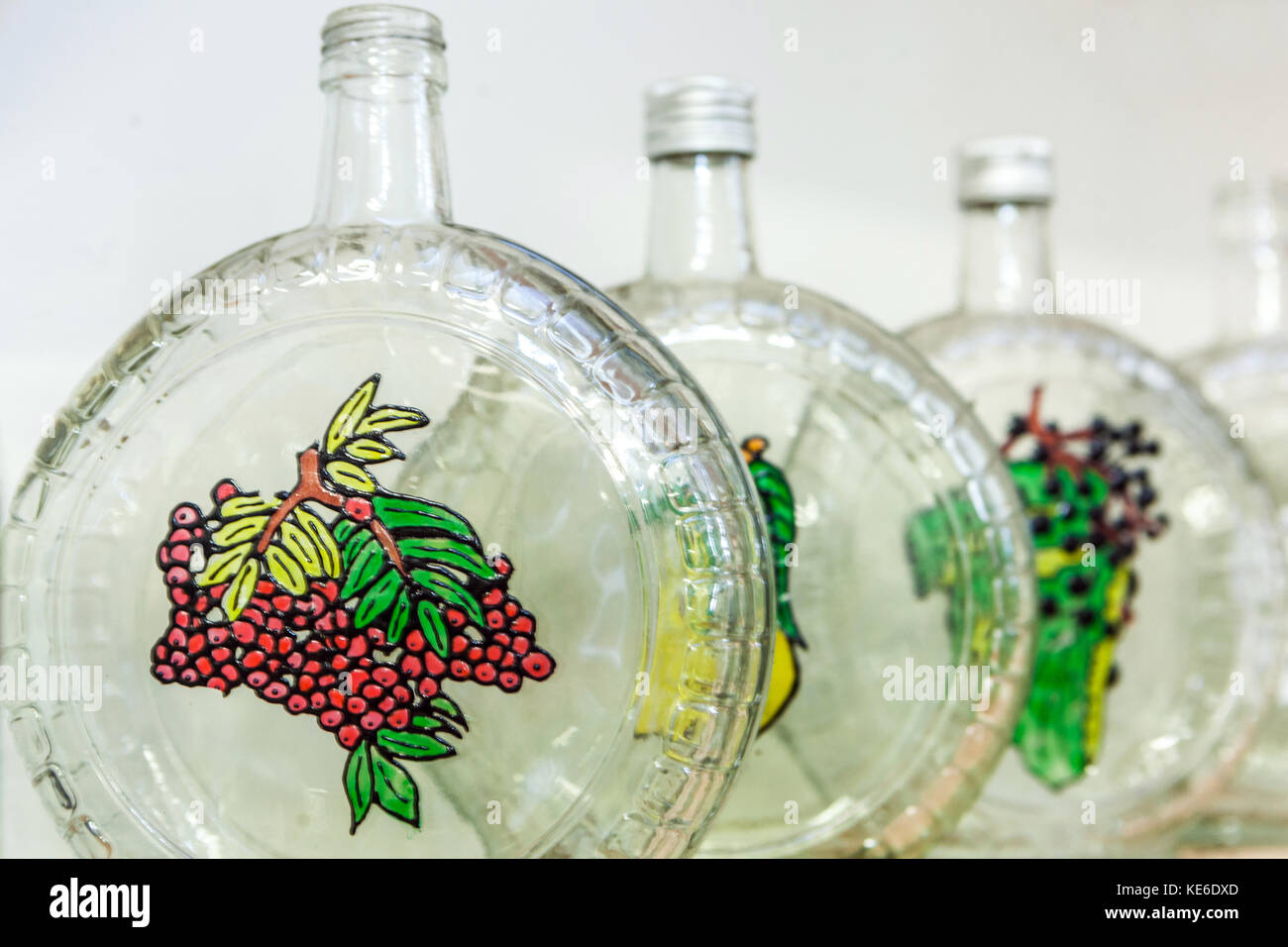 Glass bottles to distilled spirits, fruit symbols Stock Photo