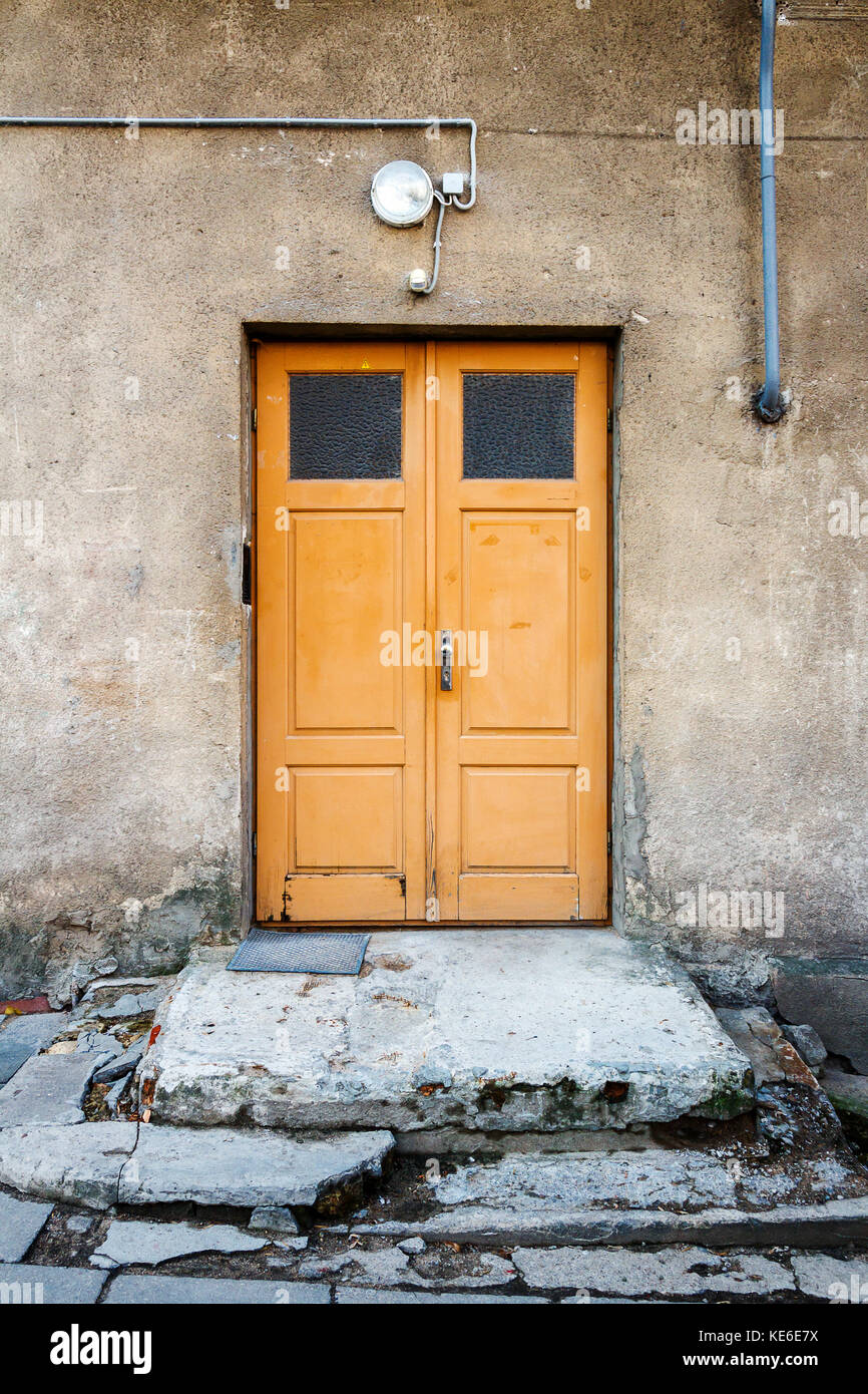 Yellow wooden door on a wall. Architecture detail background Stock Photo Alamy