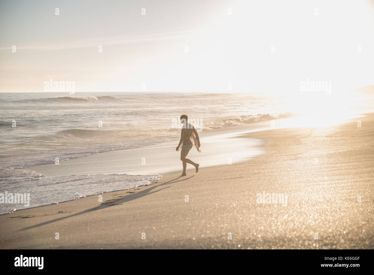 Silhouette woman walking on sunny summer ocean beach Stock Photo - Alamy