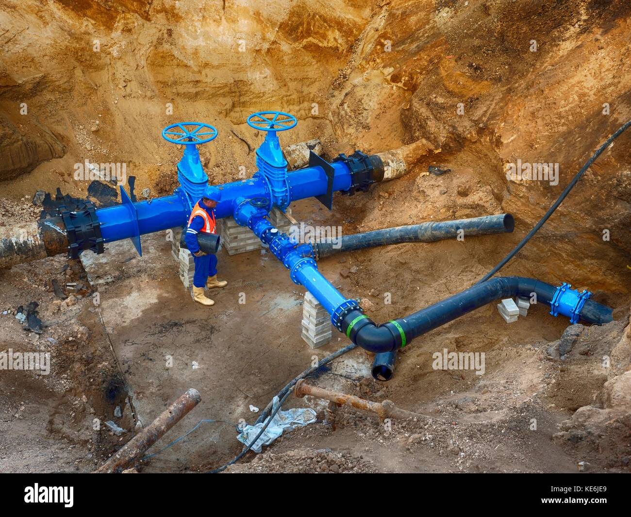 Technical expert underground at gate valve on 500mm drink water pipes joined with new black