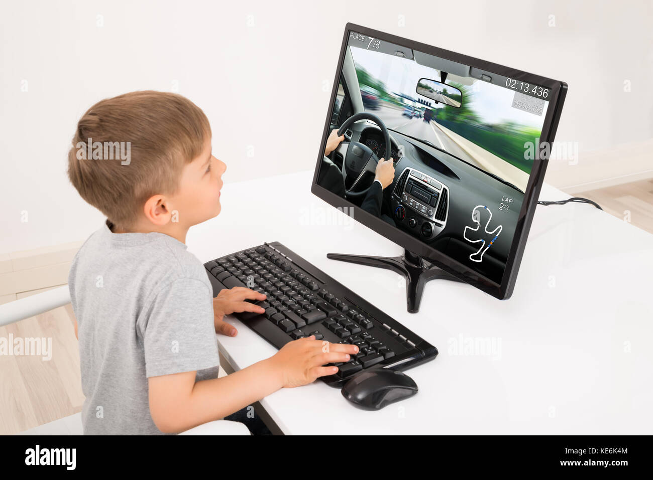 Little Boy Playing Car Game On Computer At Home Stock Photo