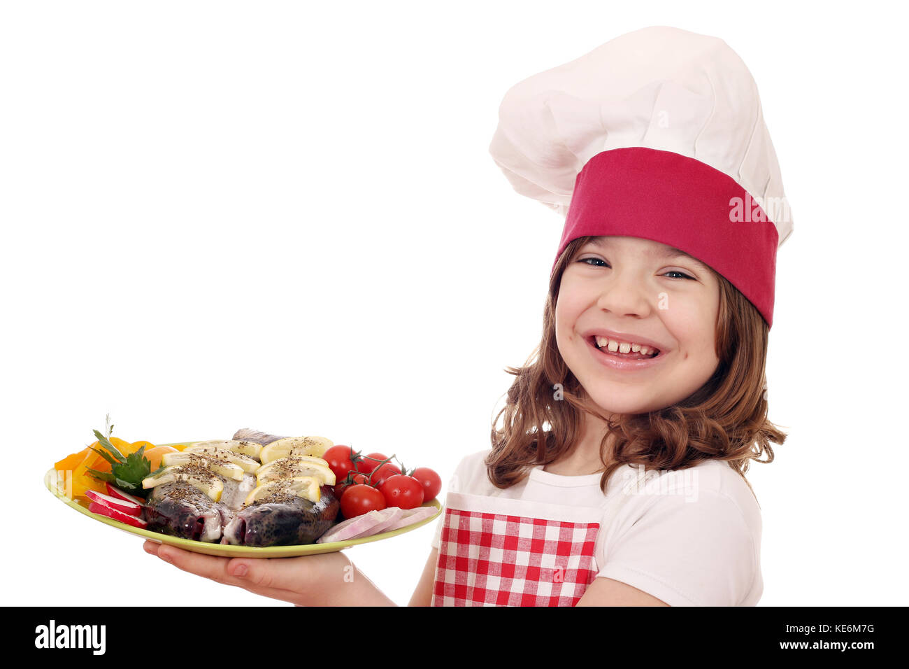 happy little girl cook with trout fish and salad on plate Stock Photo