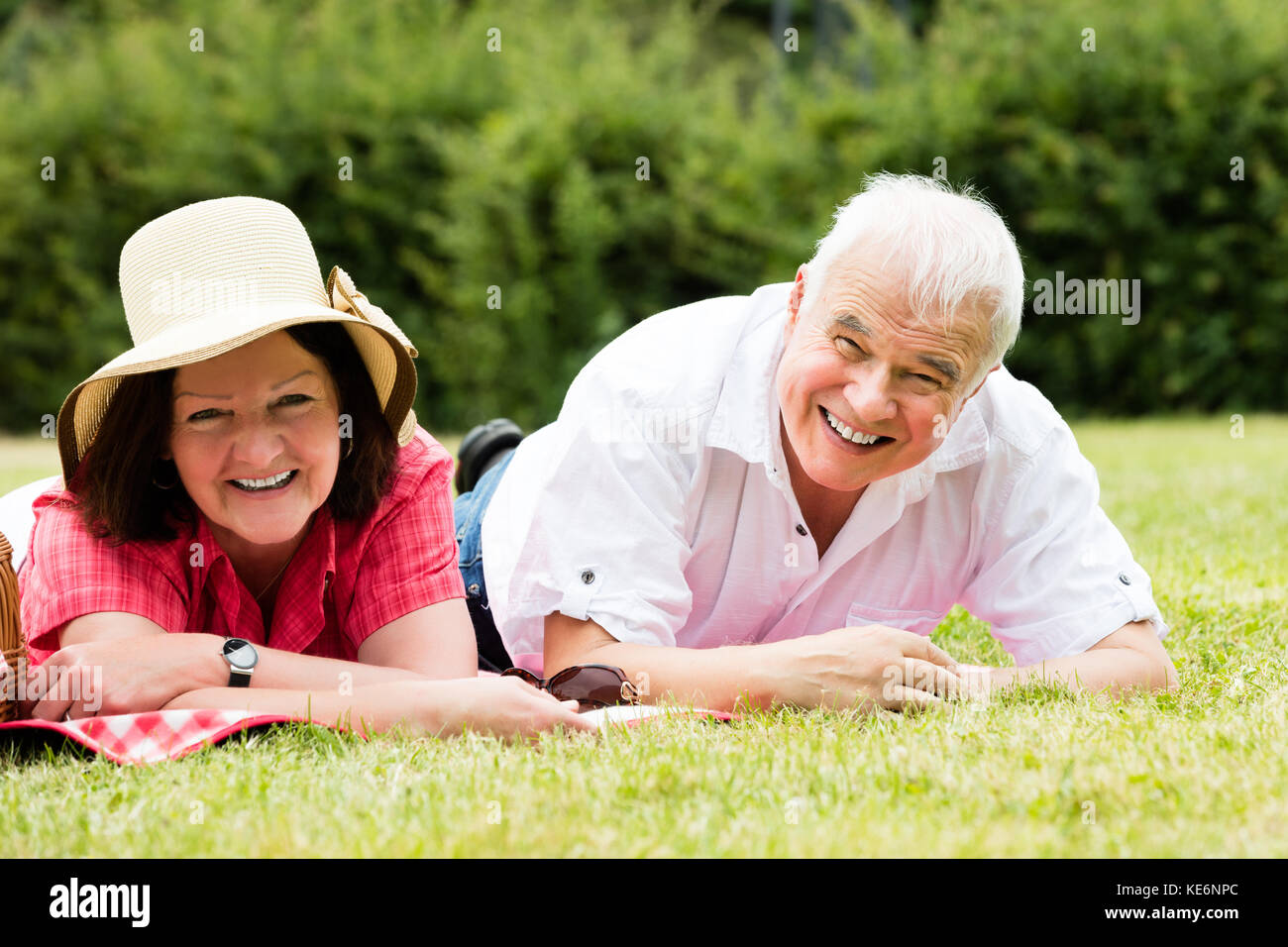 Mature woman lying on grass hi-res stock photography and images - Alamy
