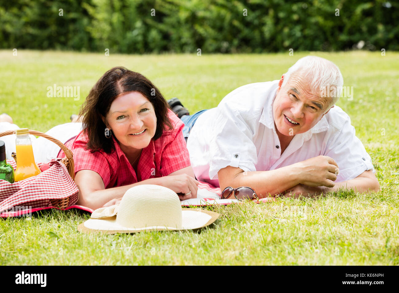 Mature woman lying on grass hi-res stock photography and images - Alamy