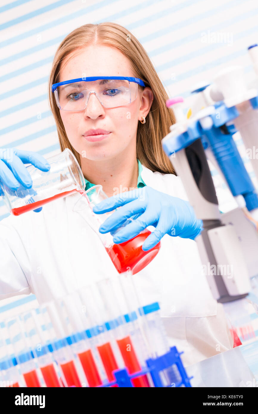 A female lab assistant doing scientific experiments in a scientific