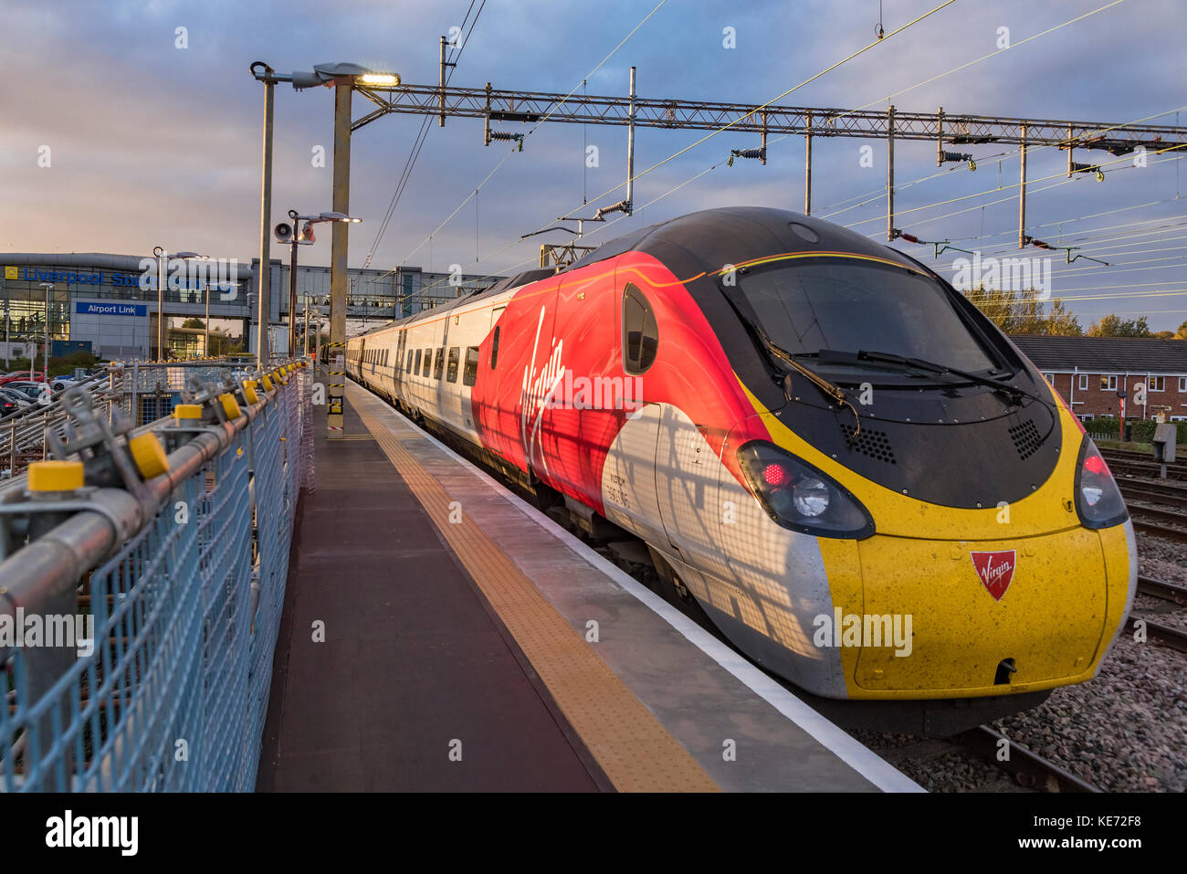 Virgin Pendolino trains at Liverpool South Parkway station. Evening light. Stock Photo