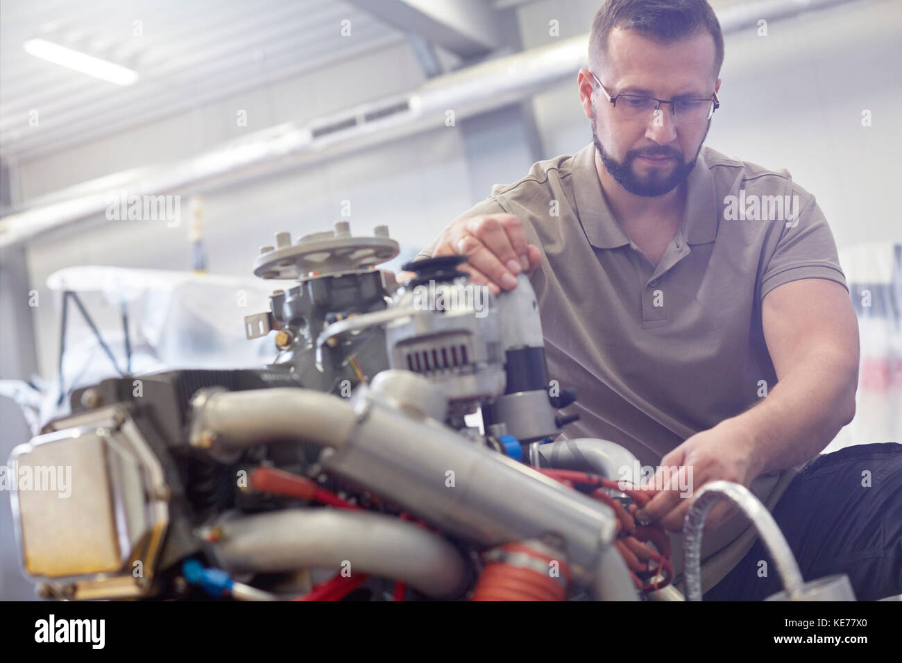 Male mechanic fixing engine Stock Photo