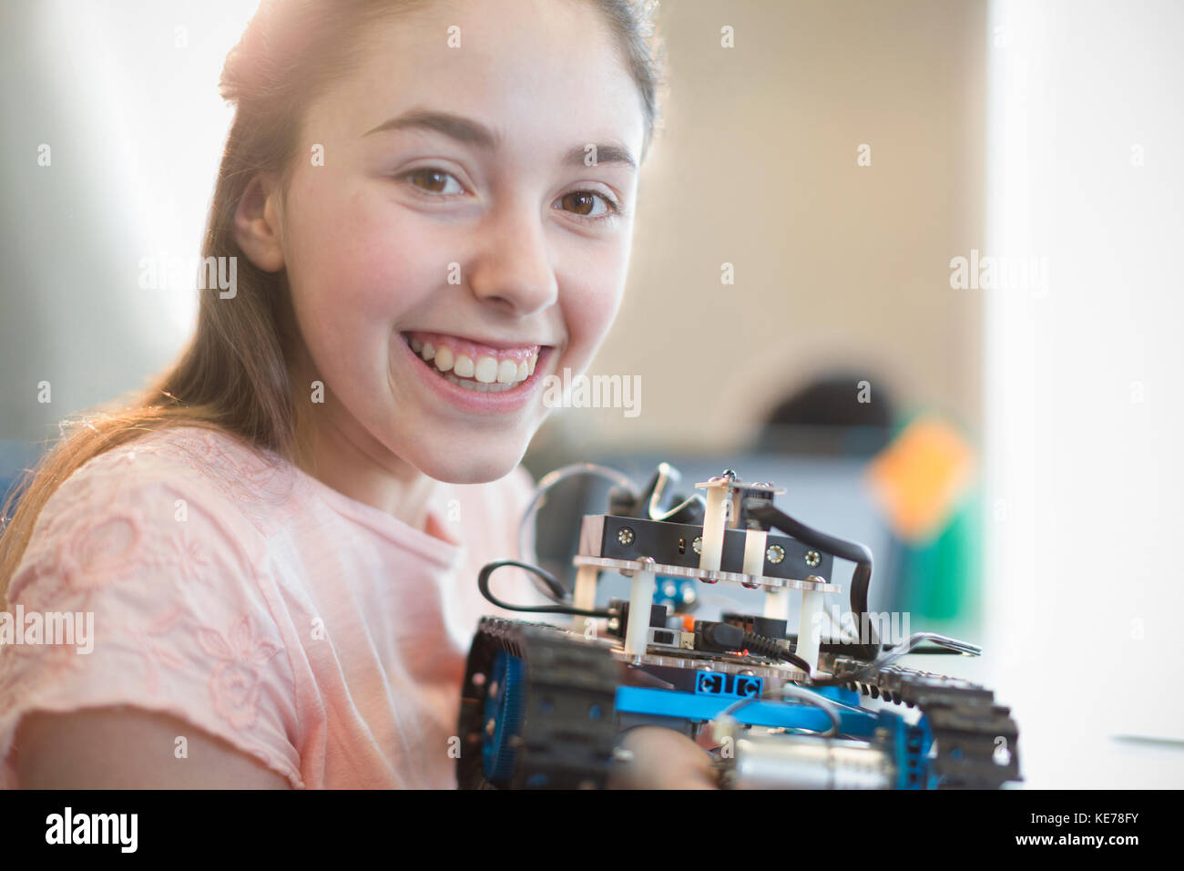 Portrait smiling, confident girl student holding robot Stock Photo