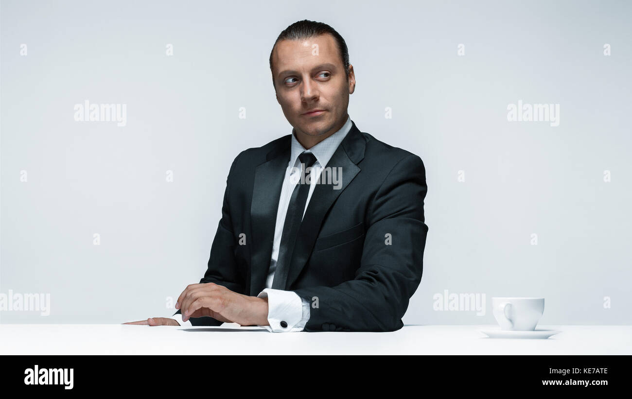 The attractive man in black suit on white background Stock Photo - Alamy