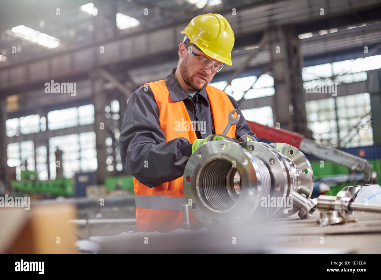 Male worker assembling steel part in factory Stock Photo