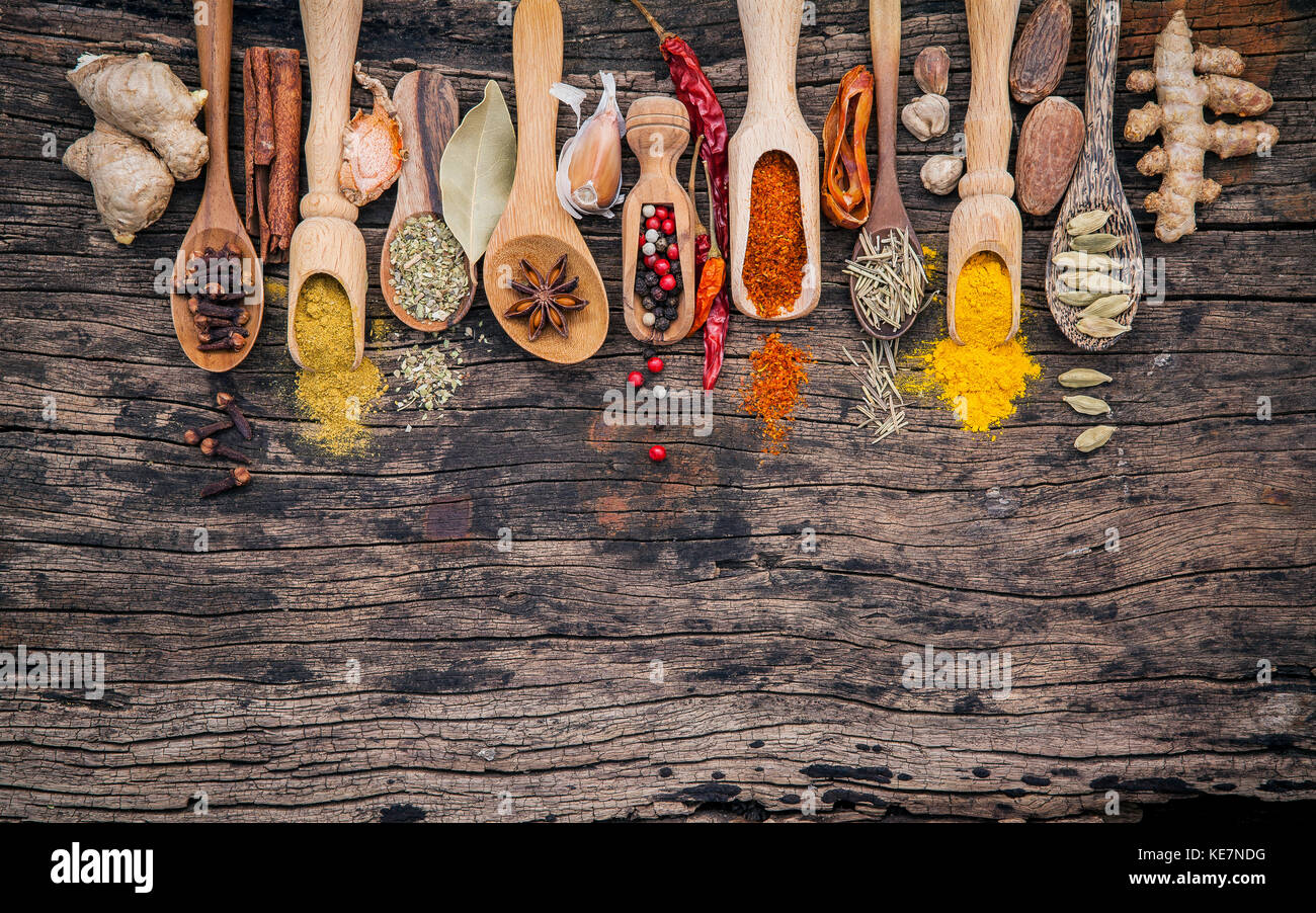 Various of spices and herbs in wooden spoons. Flat lay of spices