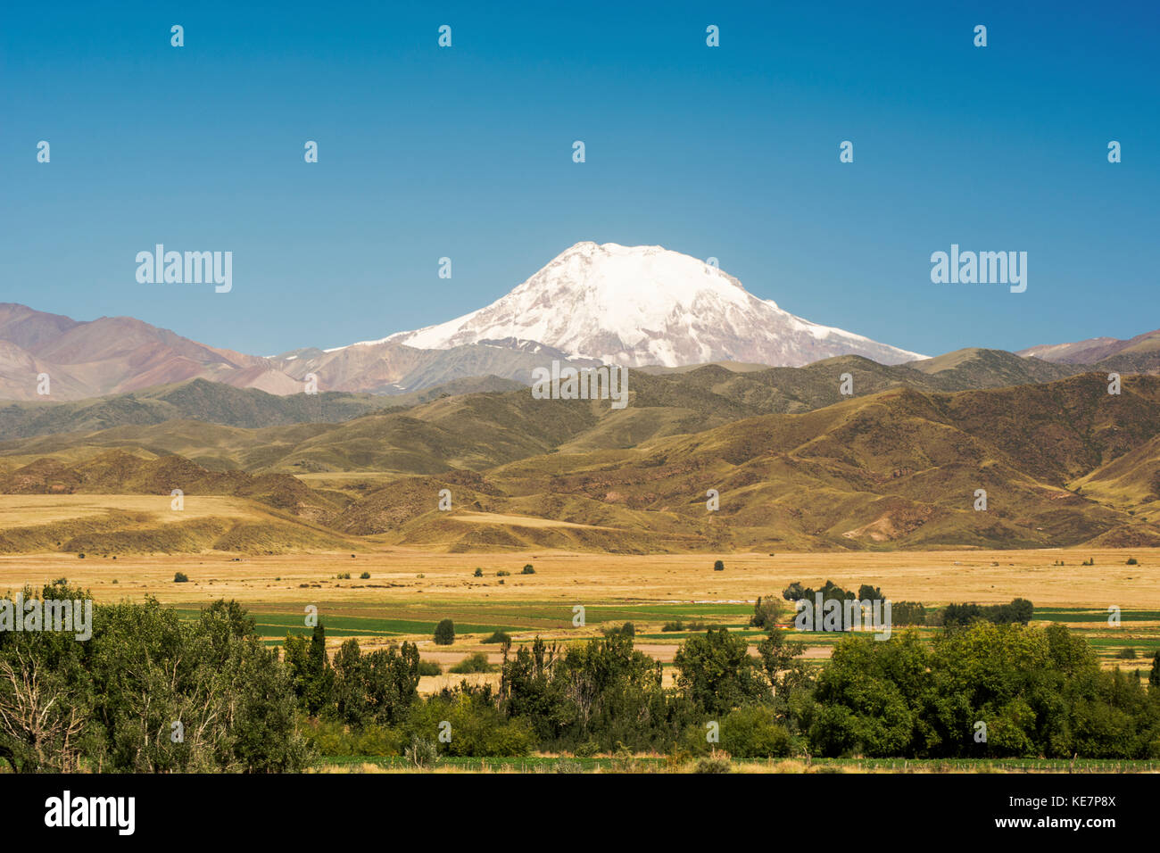 SnowCovered Volcano Towers Over The Foothills Of The Andes And