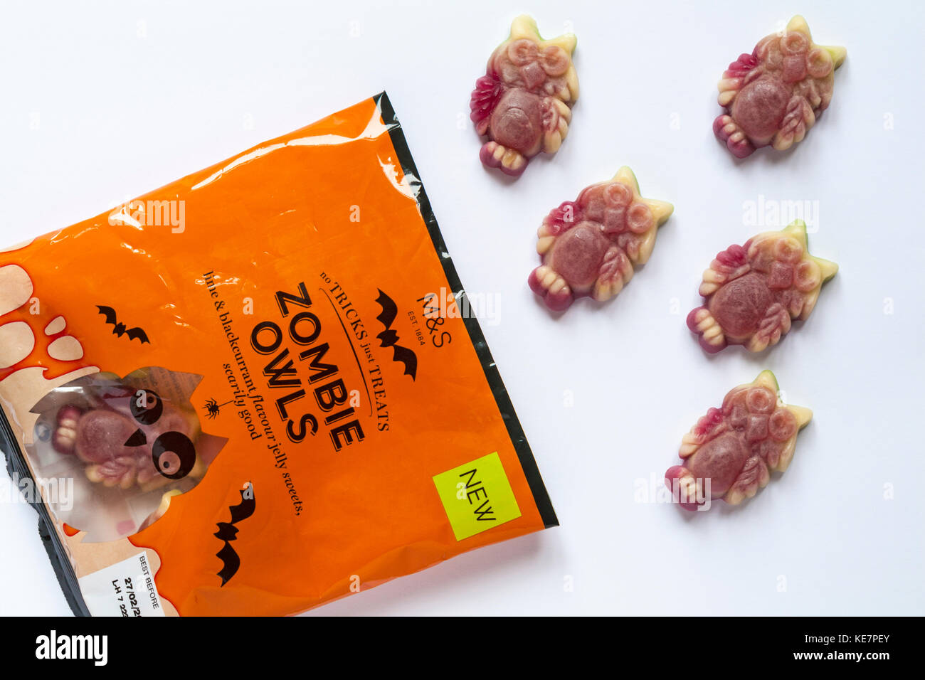 Packet of M&S Zombie Owls lime & blackcurrant flavour jelly sweets scarily good - no tricks just treats for Halloween open to show contents Stock Photo
