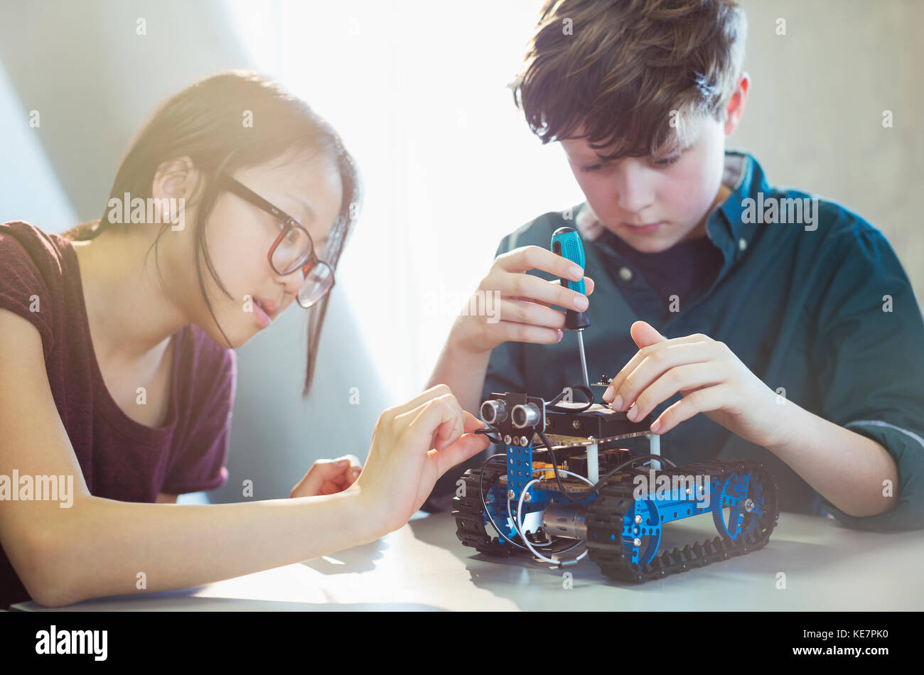 Students assembling robotics in classroom Stock Photo