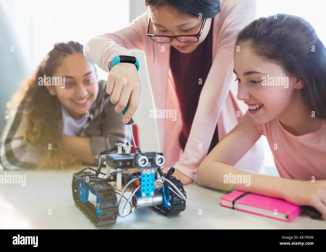 Girl students assembling robotics in classroom Stock Photo