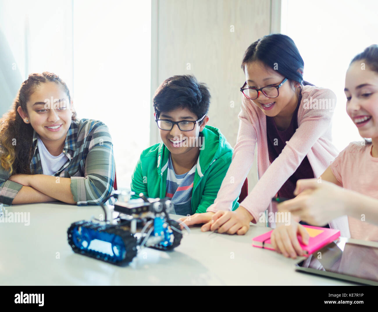 Students programming and testing robotics in classroom Stock Photo