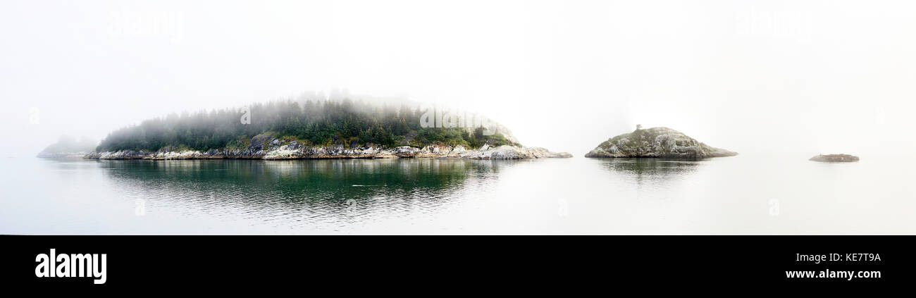 Trees On A Small Island In The Fog, Inside Passage; British Columbia, Canada Stock Photo