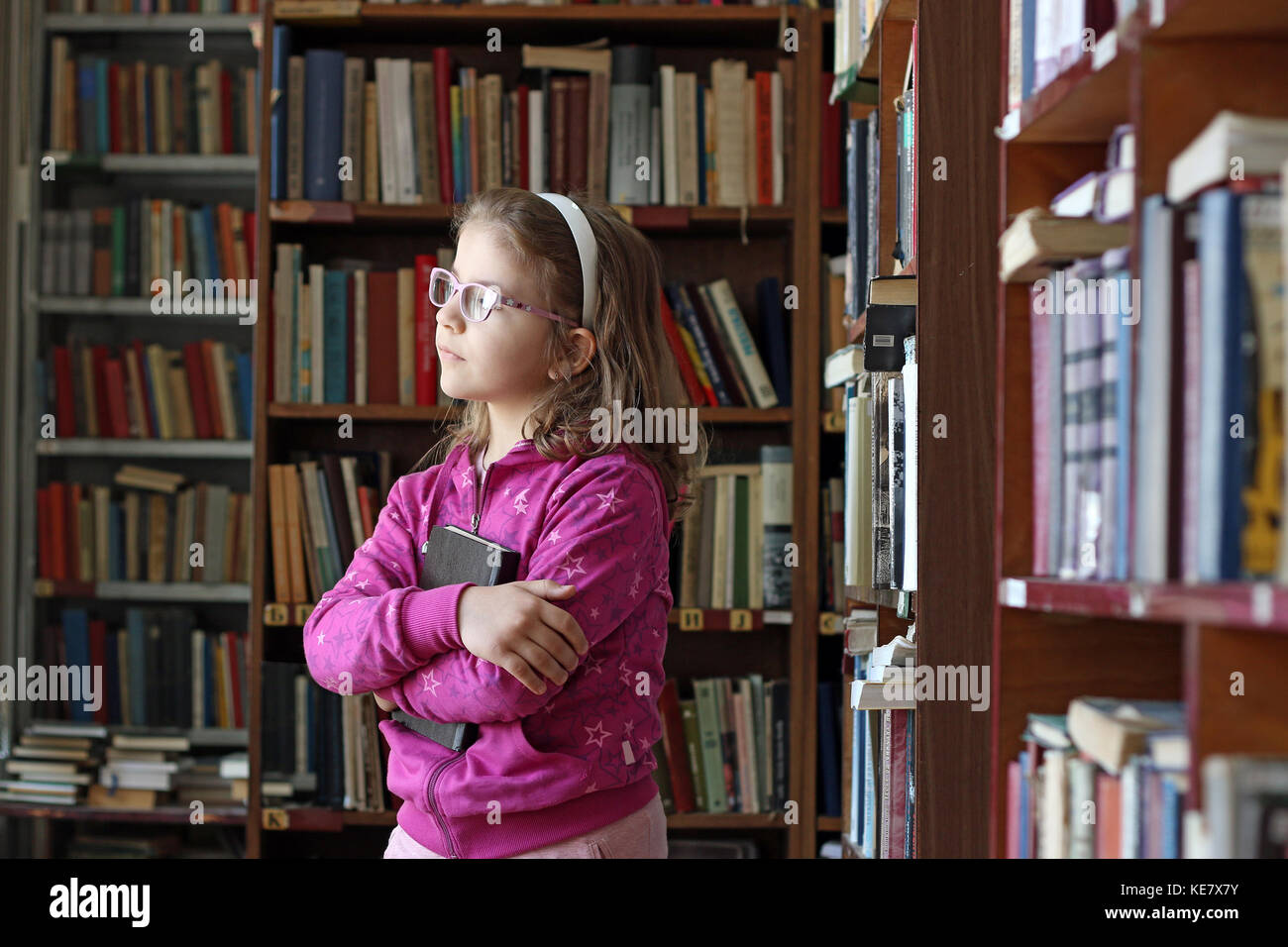 beautiful little girl in library Stock Photo