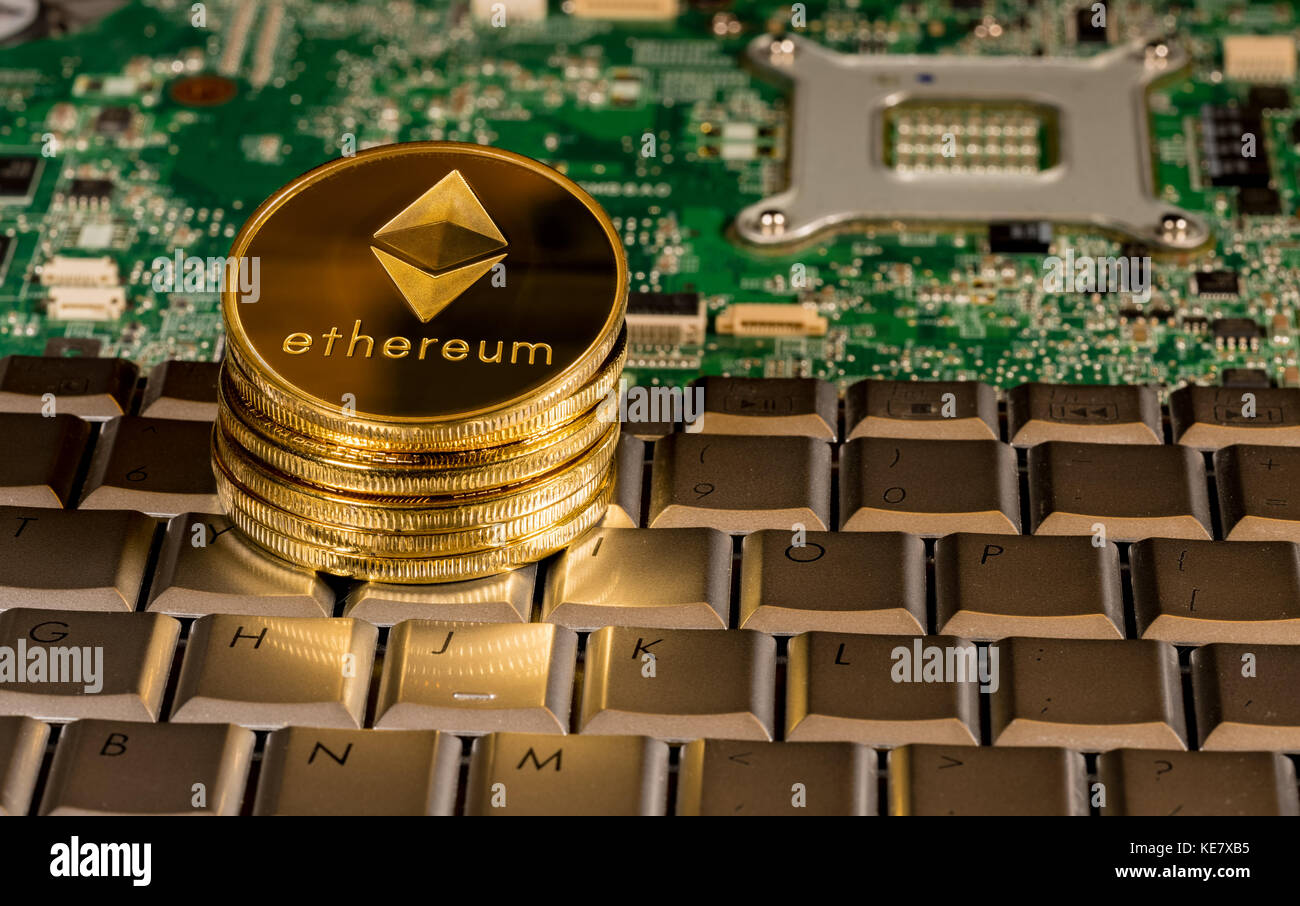 Ethereum coin on a keyboard with printed circuit board Stock Photo