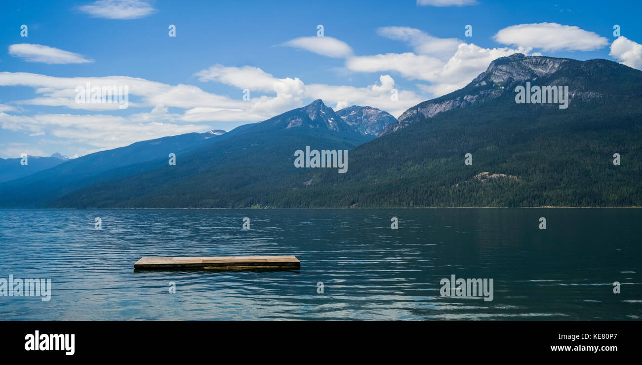 A wooden dock floating in Kootenay Lake in the Selkirk Mountains; Nelson, British Columbia, Canada Stock Photo