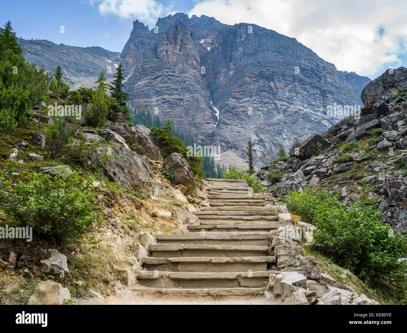 Steps leading up a towards a rugged mountain on a mountain trail in Banff National Park; Alberta, Canada Stock Photo