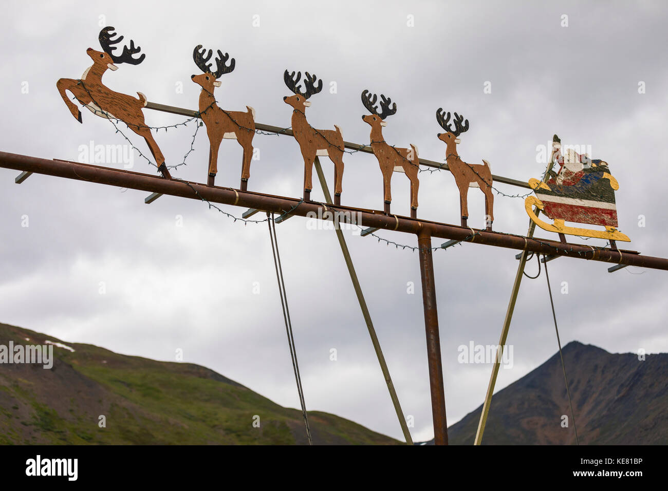 This out-of-place decorative scene of Santa Claus with his reindeer sleigh is attached to a light post at the Alaska DOT Chandalar Maintenance Camp... Stock Photo