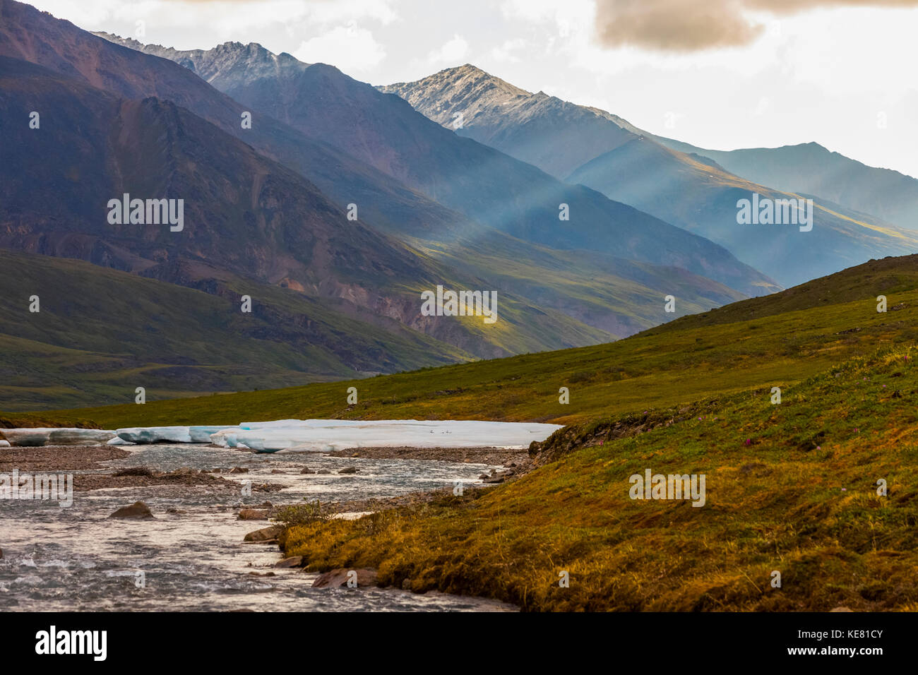 Light penetrates the clouds in a valley in the Brooks Range; Alaska, United States of America Stock Photo