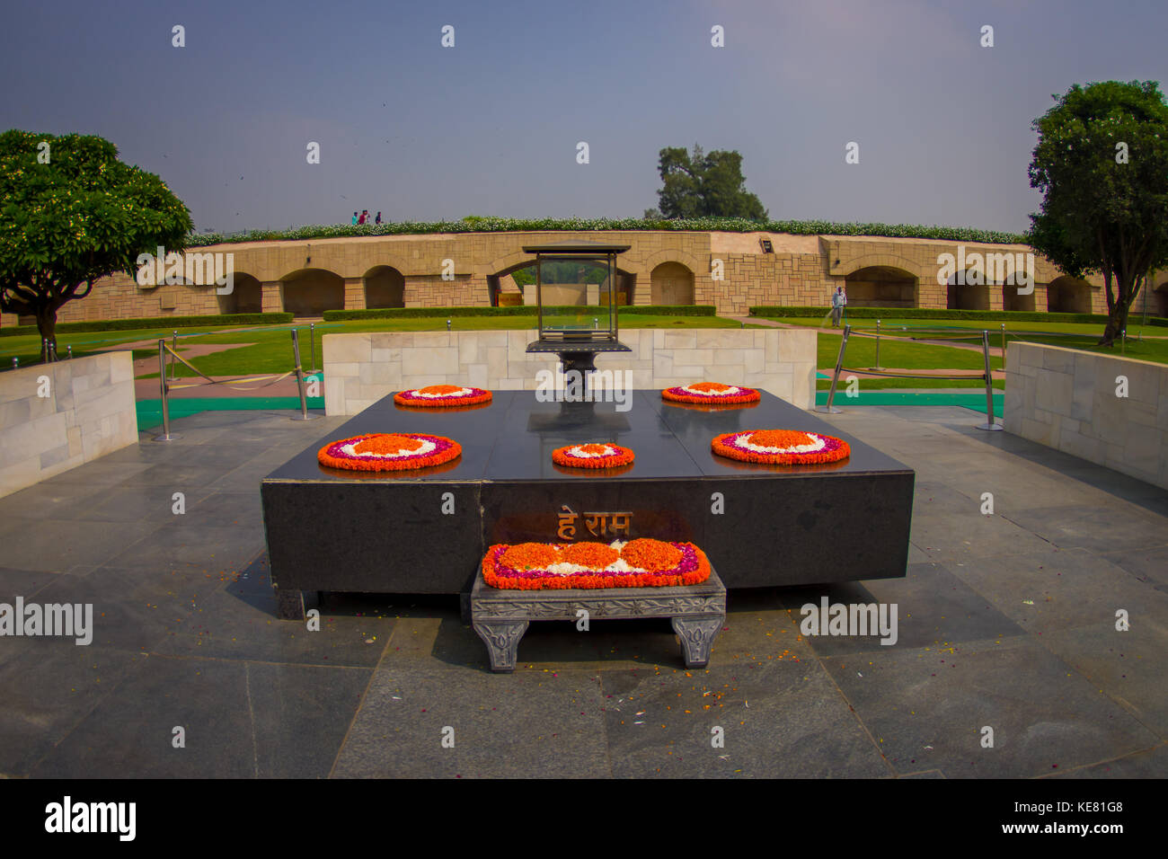 DELHI, INDIA - SEPTEMBER 25 2017: Beautiful grave in Rajghat, New Delhi as memorial at Mahatma Gandhis body cremation place, with some beautiful flowers over the grave in Delhi India Stock Photo